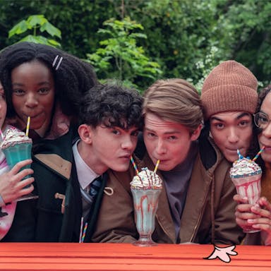 Three pairs of young people each share a milkshake.