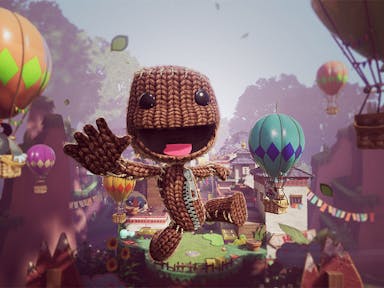 Animated video game image of a knitted creature flying through the air, smiling, with hot air balloons all around him in the sky. 