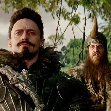 Four white men in fantasy pirate style looking menacing clothing in a jungle 