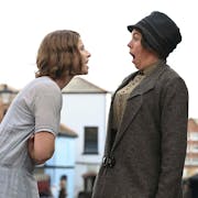 A young white woman saying something shocking to a middle aged white woman who looks shocked and offended