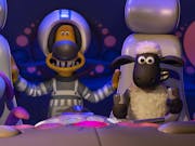 Claymation of characters, a bunny-type, dog and sheep, sitting in a spaceship