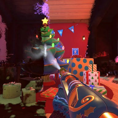 Gameplay of a cartoon powerwash gun head with a mitten-ed hand washing soot off to reveal a colourful Christmas tree and presents 
