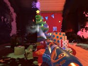 Gameplay of a cartoon powerwash gun head with a mitten-ed hand washing soot off to reveal a colourful Christmas tree and presents