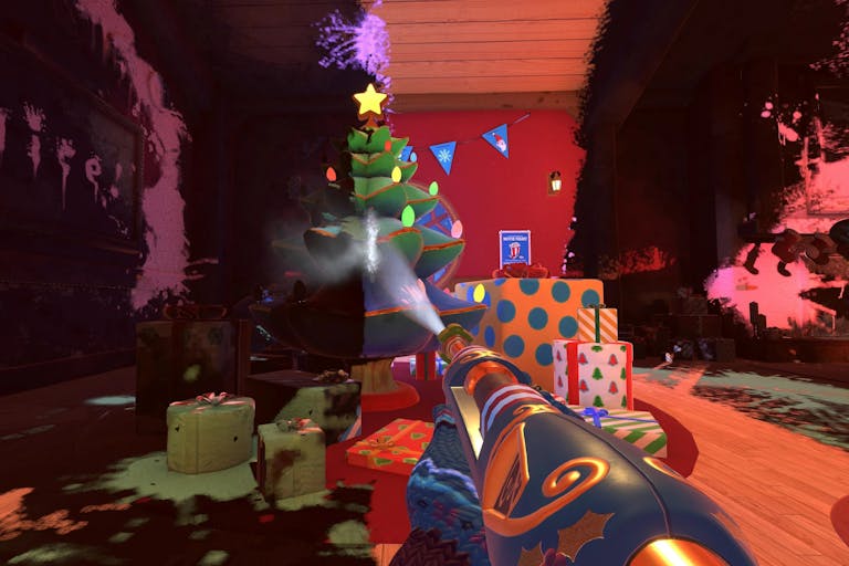 Gameplay of a cartoon powerwash gun head with a mitten-ed hand washing soot off to reveal a colourful Christmas tree and presents 