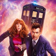 A red headed white woman and a dark haired white man in long blue coat, run away from cosmic galaxy activity with the TARDIS, a blue police box, in the background
