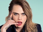Young woman with blond hair pulls a shocked face