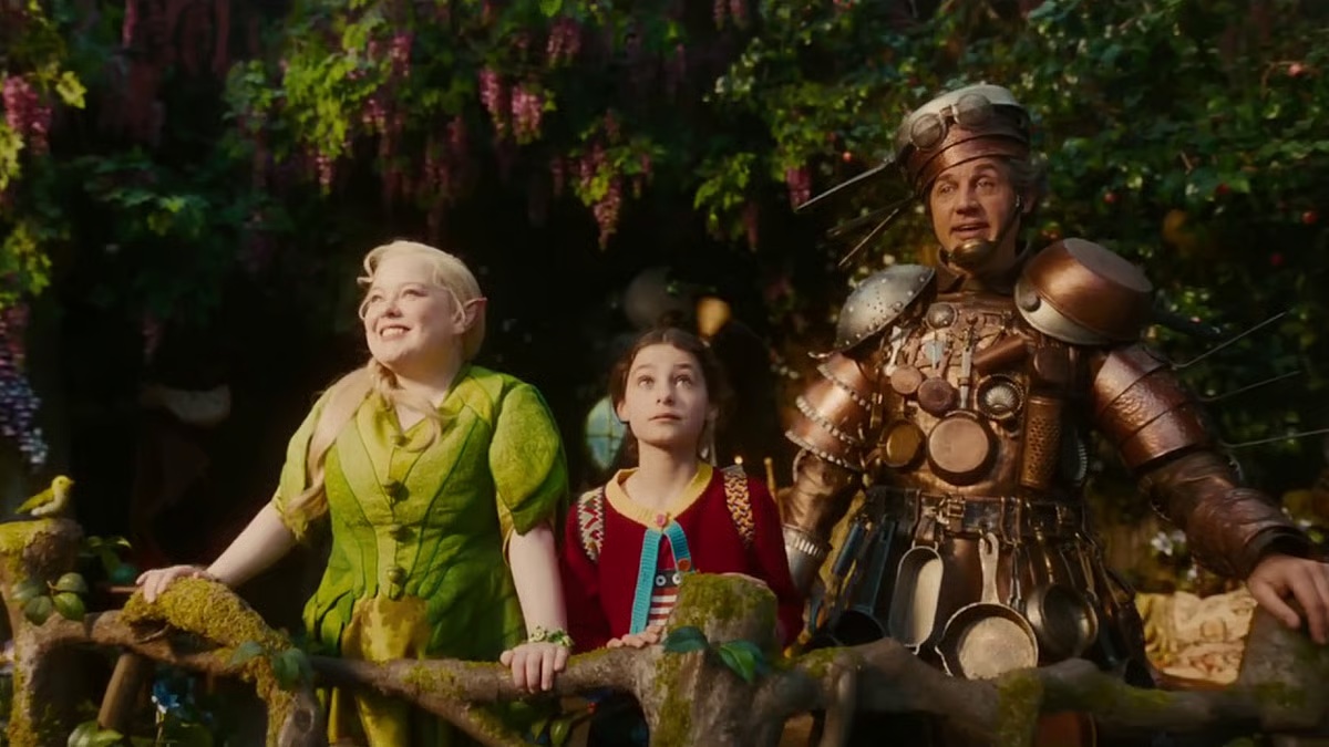 From left to right: A blonde haired fairy woman, a young girl, and a tin man. All standing in a tree