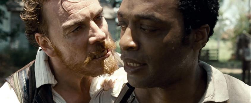 An angry-faced white man shouting in the face of a black man
