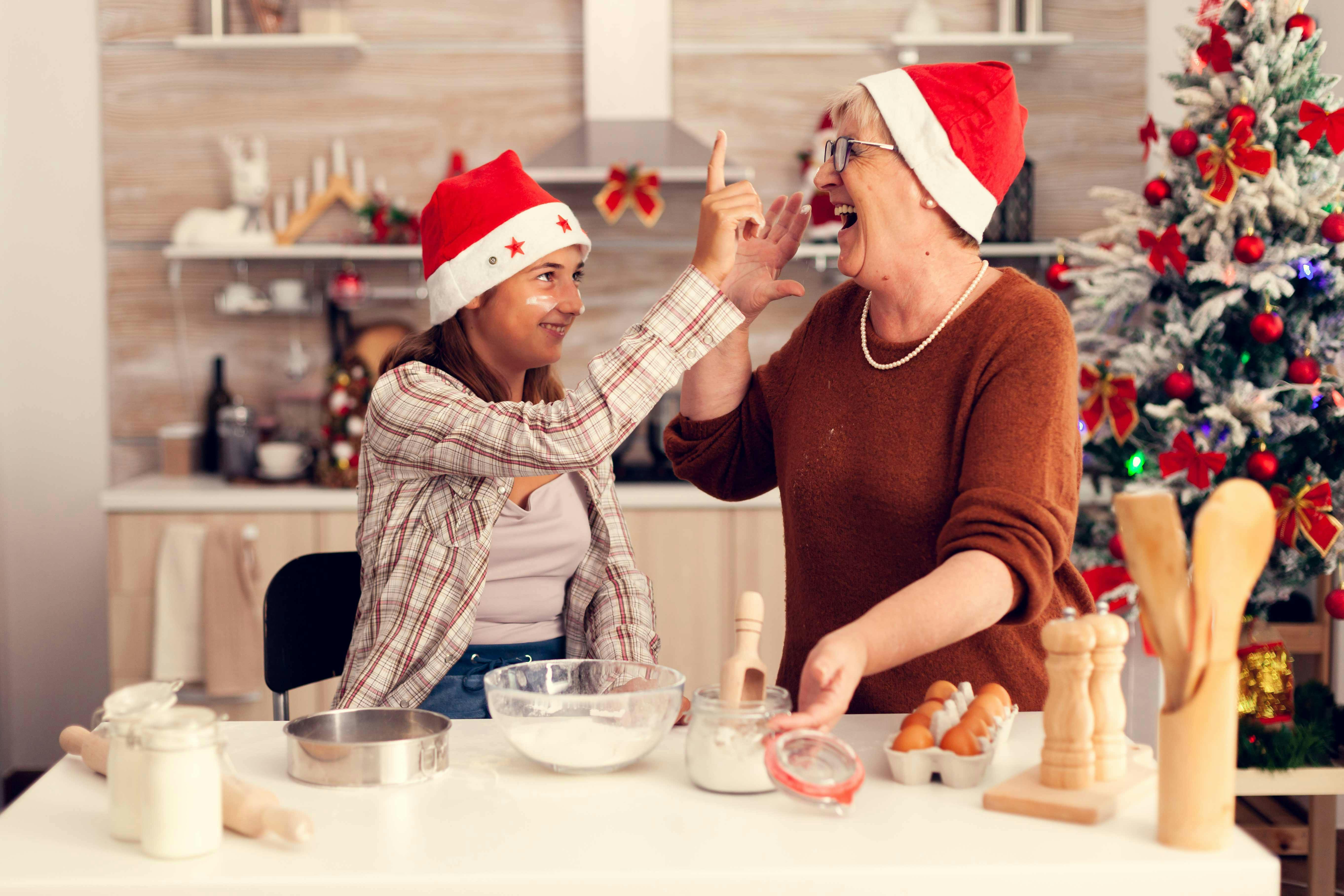 Having fun while cooking in Santa hats.