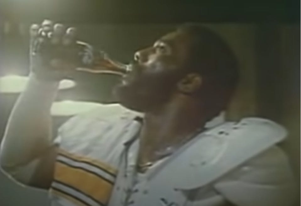 Mean Joe Green drinking a Coke