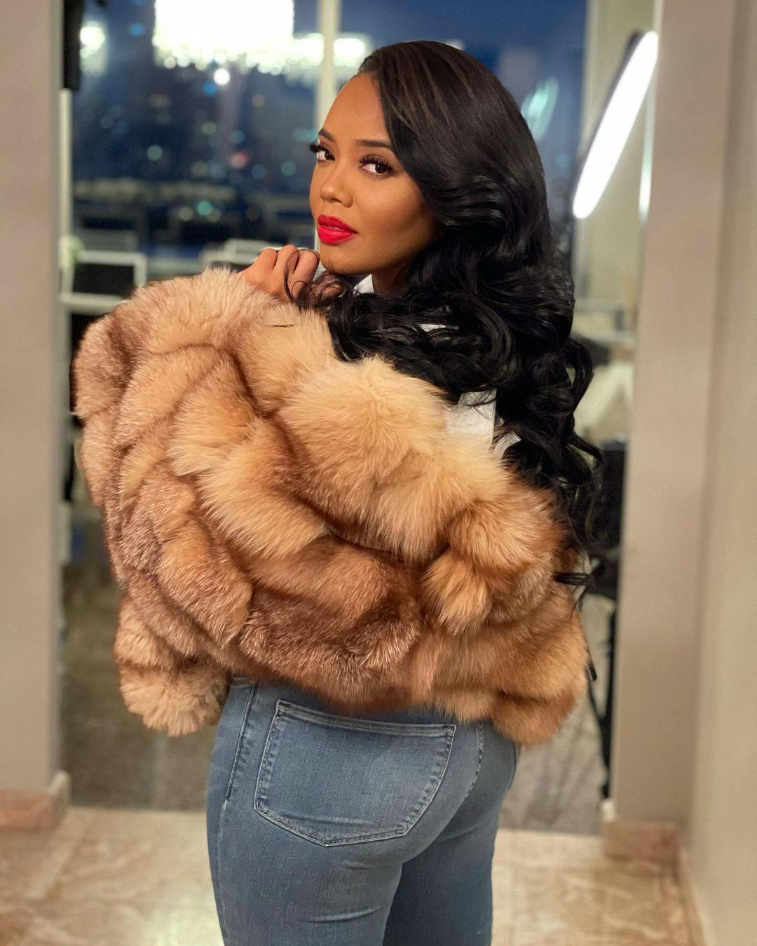 Angela Simmons' in blue jeans.