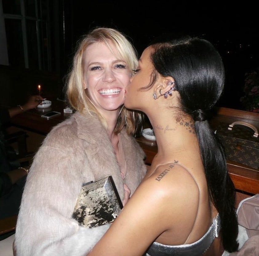 January Jones getting a kiss from Rihanna