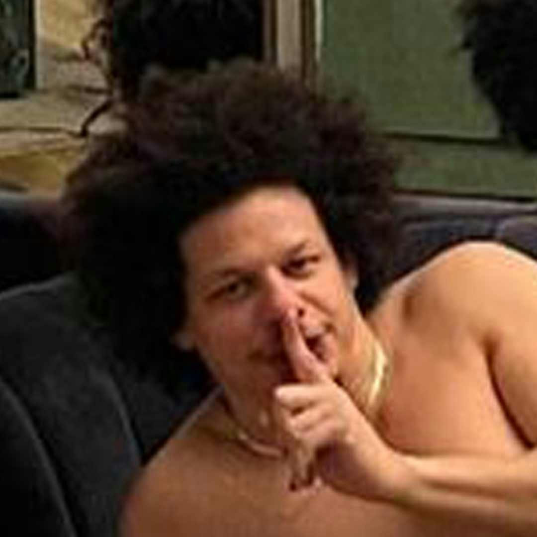 Eric Andre with his hand over his mouth
