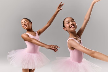 Two young ballet dancers smiling, wearing pink leotards with matching tutus, photographed in a studio against a neutral background, each captured in a different pose with arms raised, shown in a double composition illustrating movement and expression.