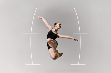 A ballet dancer wearing a black leotard, captured mid jump with arms extended and legs bent, photographed in a studio against a neutral background. White graphic lines and arcs inspired by Benesh notation surround the figure, structuring axis, elevation, and movement trajectory.