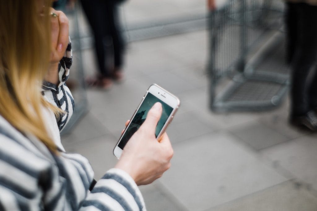 Person holding their mobile phone