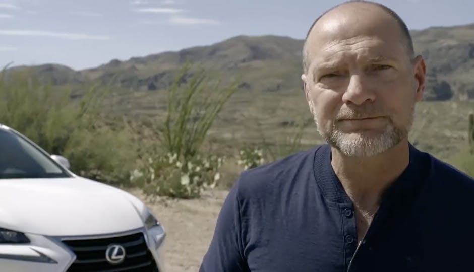 Less Stroud in front of a Lexus in a commercial edited by Will Cyr.