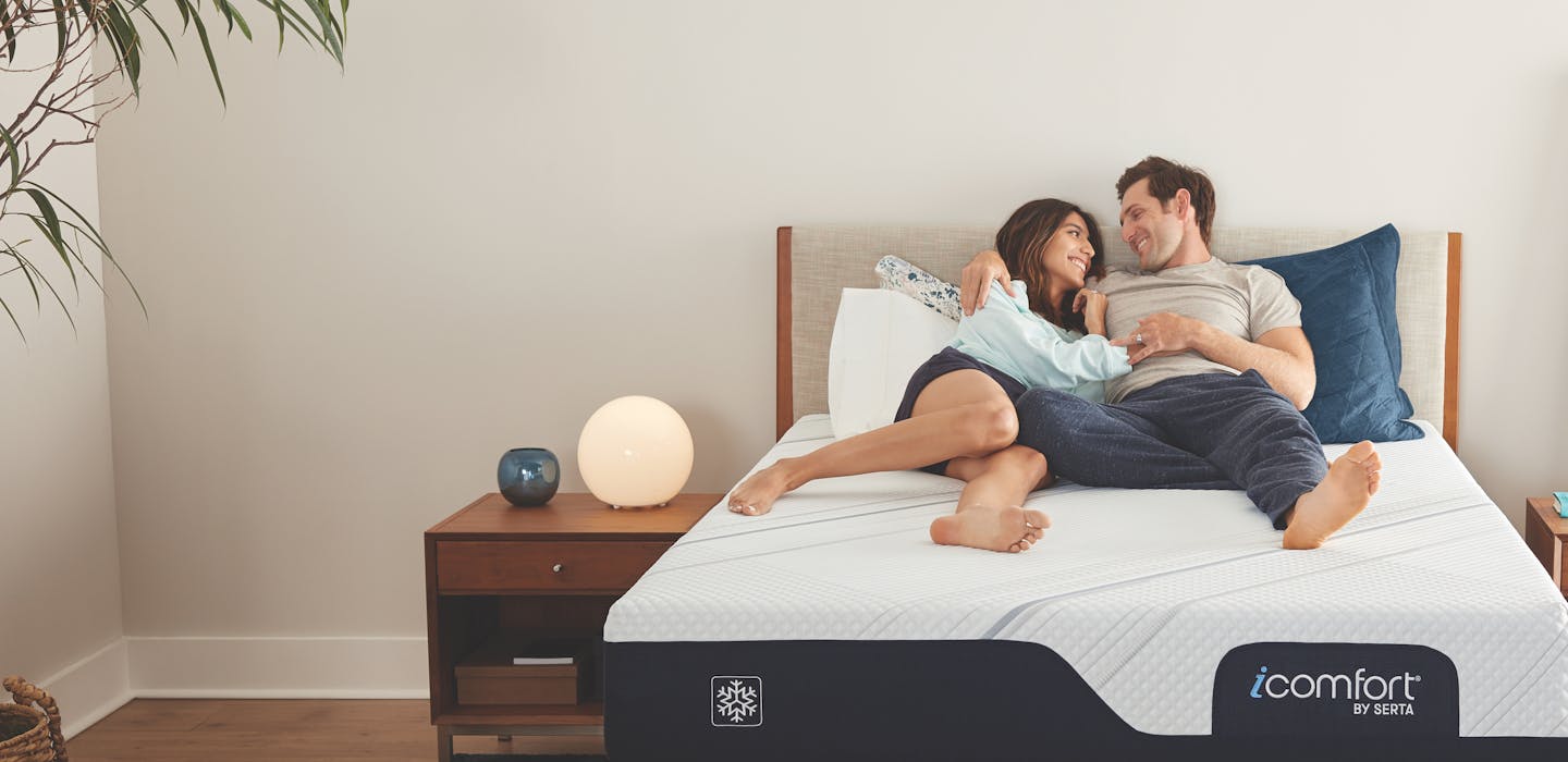 A couple laying on an iComfort mattress.