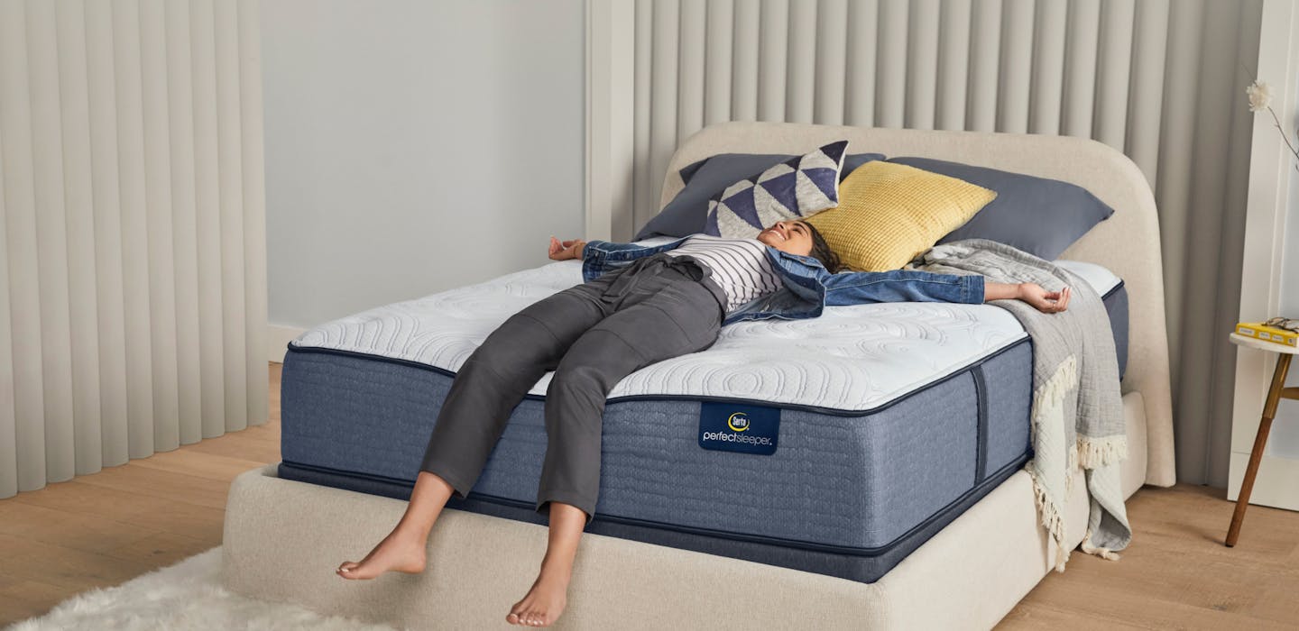 Woman Laying Down on a Serta Perfect Sleeper Bed