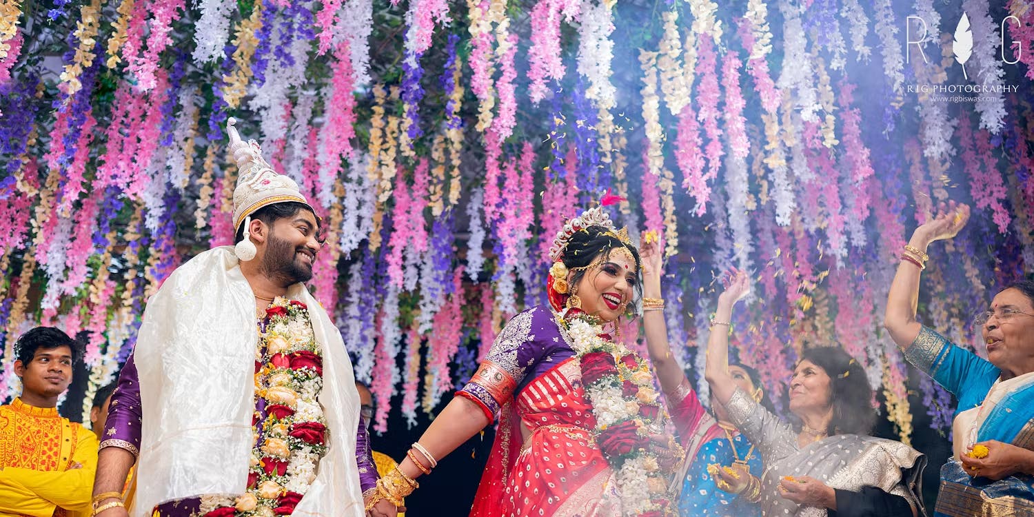 Bride and groom taking wedding pheras image