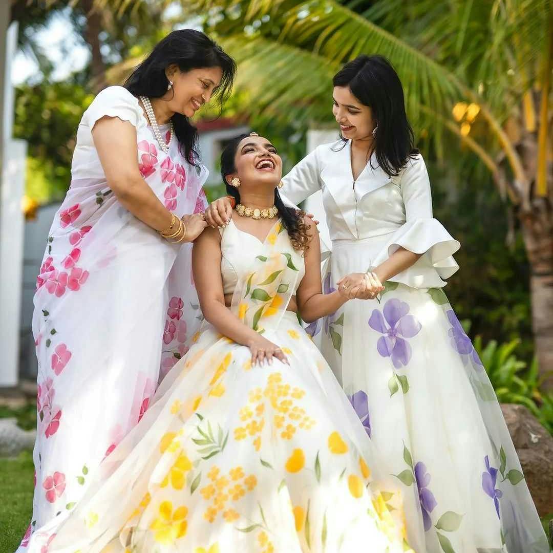 Bride candid pose with mother and sister