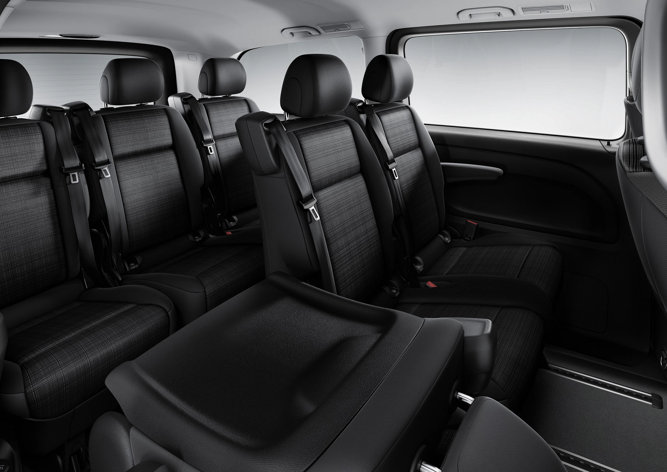 Innenraum eines Fahrzeugs mit drei Sitzreihen in schwarzer Polsterung, Sicherheitsgurte vorhanden. Modernes Design mit ergonomischen Sitzen.