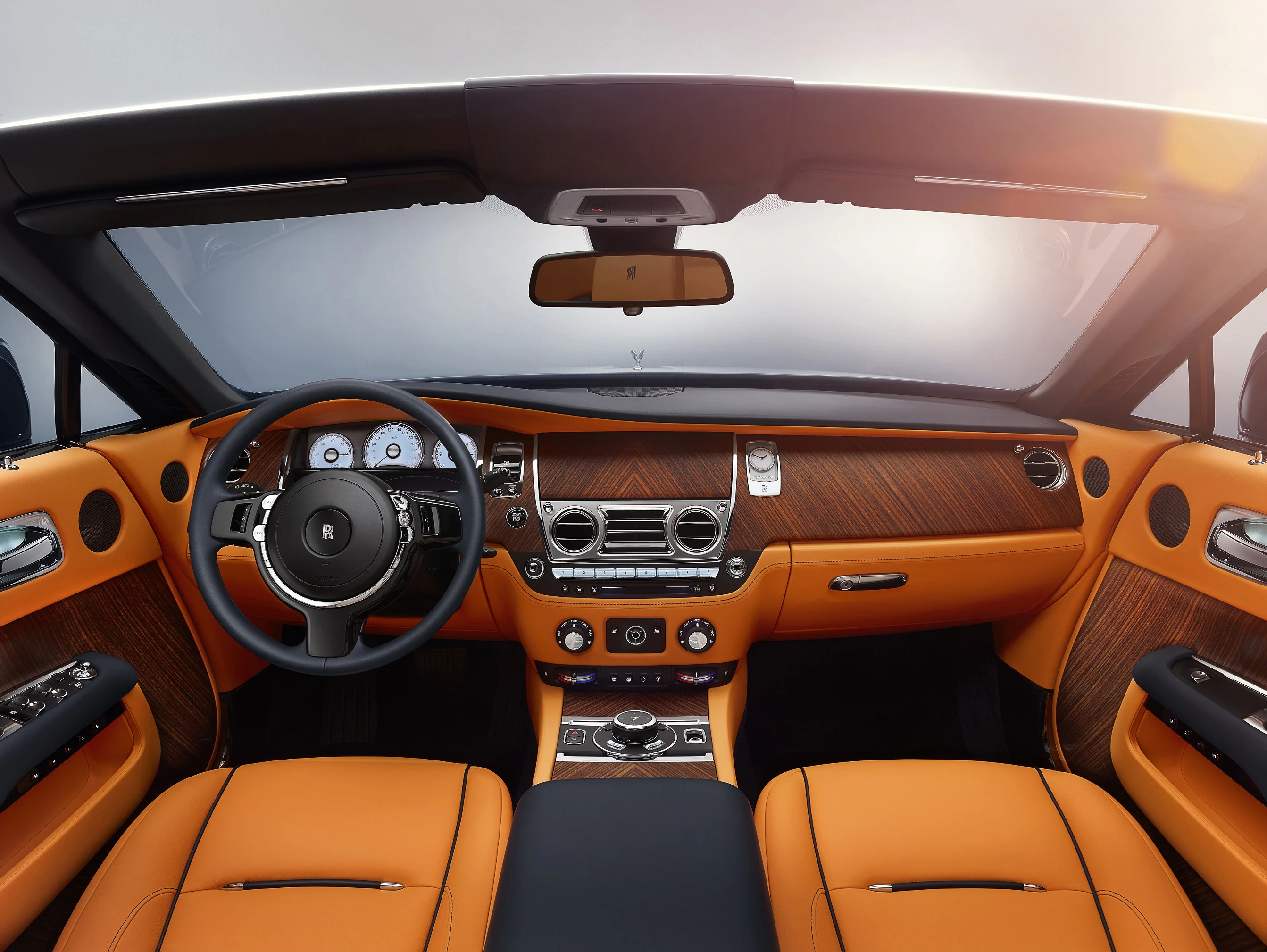 Luxuriöser Auto-Innenraum mit orangefarbenen Ledersitzen, Holzverkleidung, modernem Lenkrad und digitalem Armaturenbrett bei Tageslicht.
