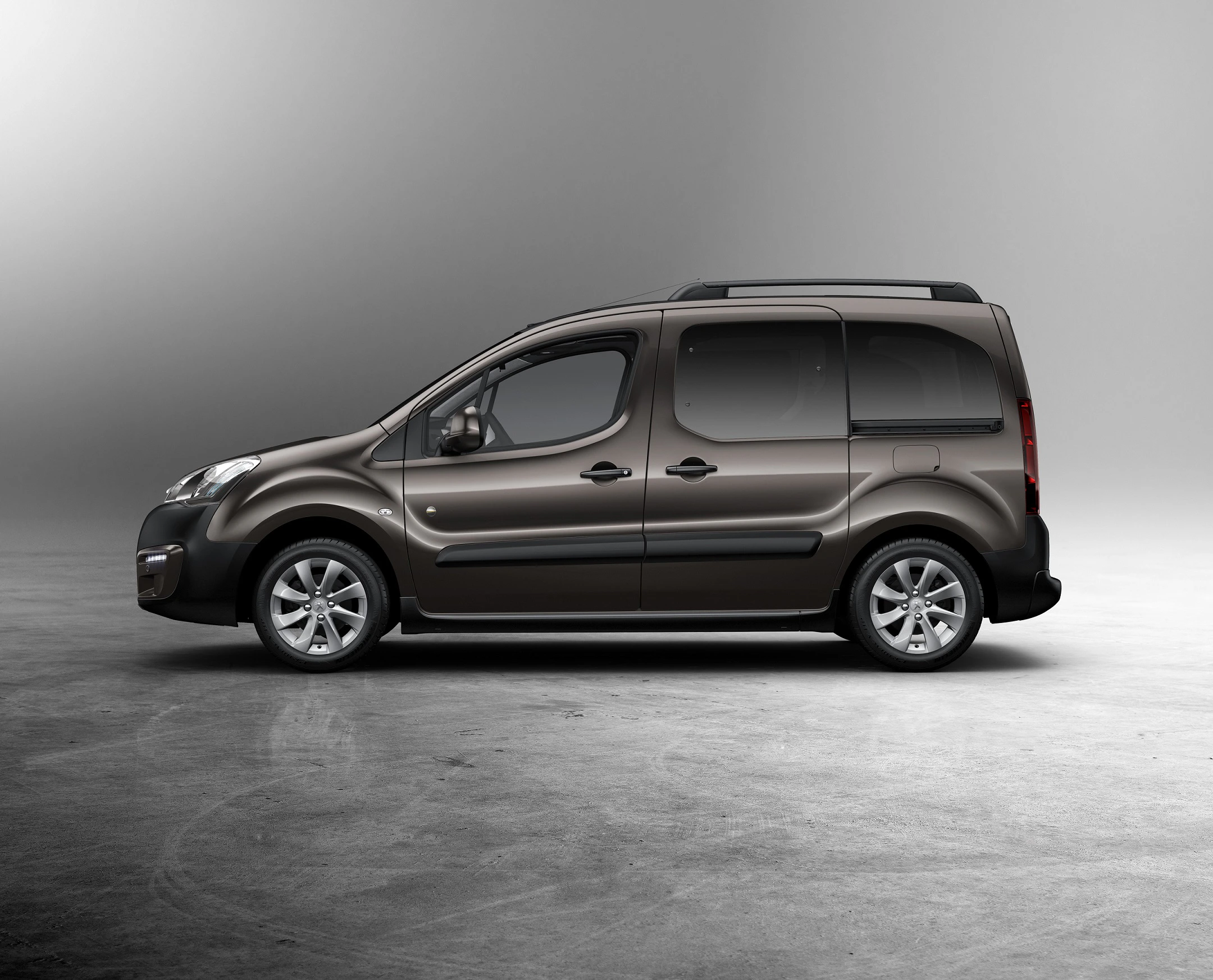 Dunkelgrauer Minivan auf grauem Hintergrund, seitliche Ansicht, mit modernem, funktionalem Design und dezenter Linienführung.