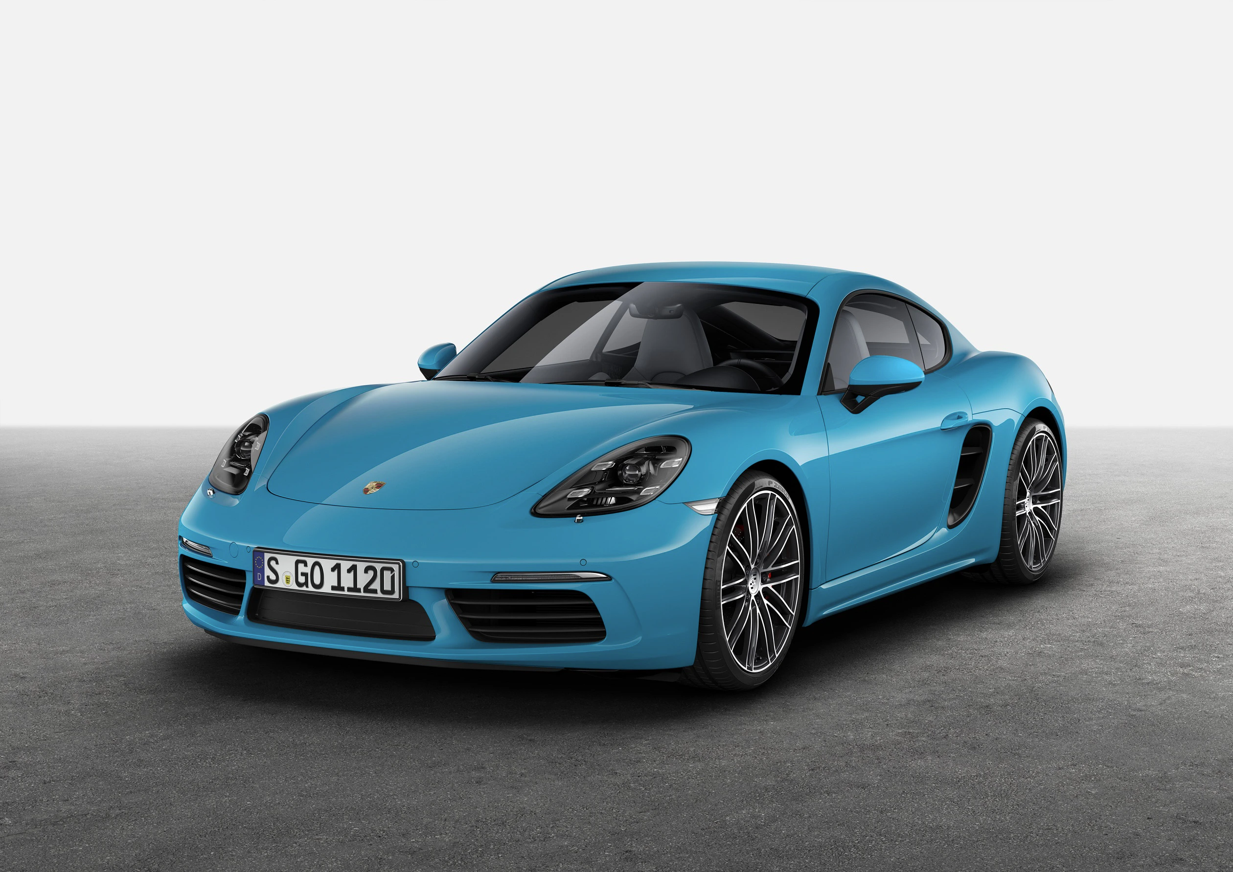 Blauer Sportwagen auf grauem Untergrund, mit eleganter Form und markanten Scheinwerfern, Frontansicht.