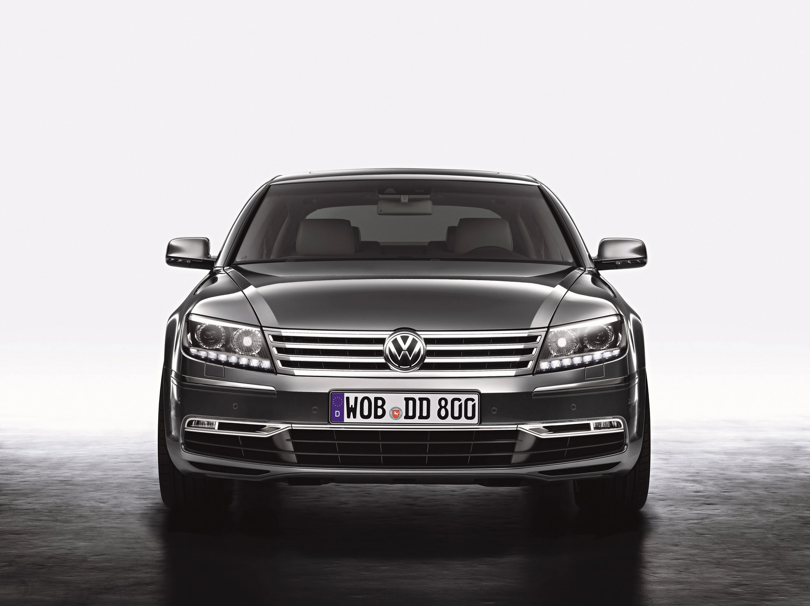 Frontansicht eines schwarzen Volkswagen Phaeton mit EU-Kennzeichen auf grauem Hintergrund.