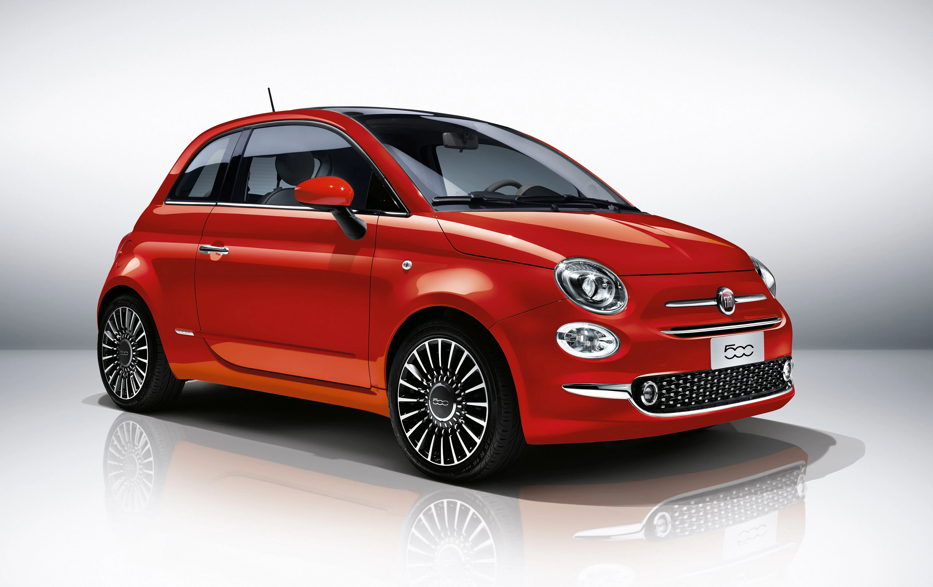 Roter Fiat 500 mit glänzenden Felgen, vor weißem Hintergrund fotografiert.