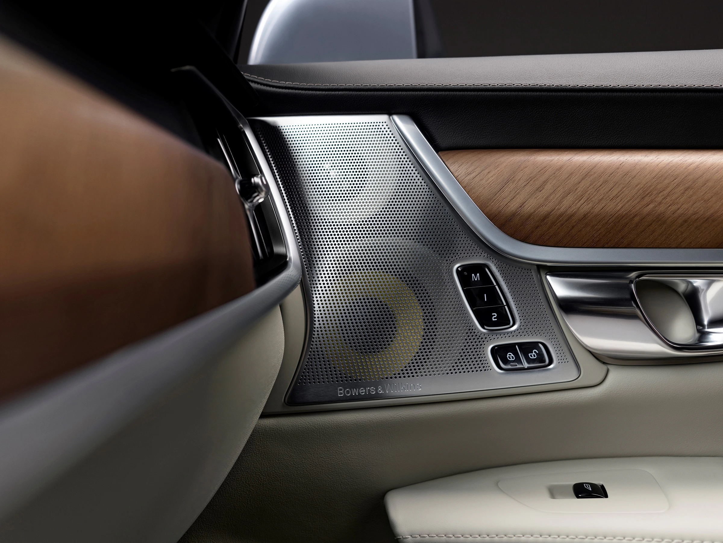 Detailansicht einer Autotür mit Holz- und Metallapplikationen, Bowers & Wilkins Lautsprecher und Sitzverstellungstasten.
