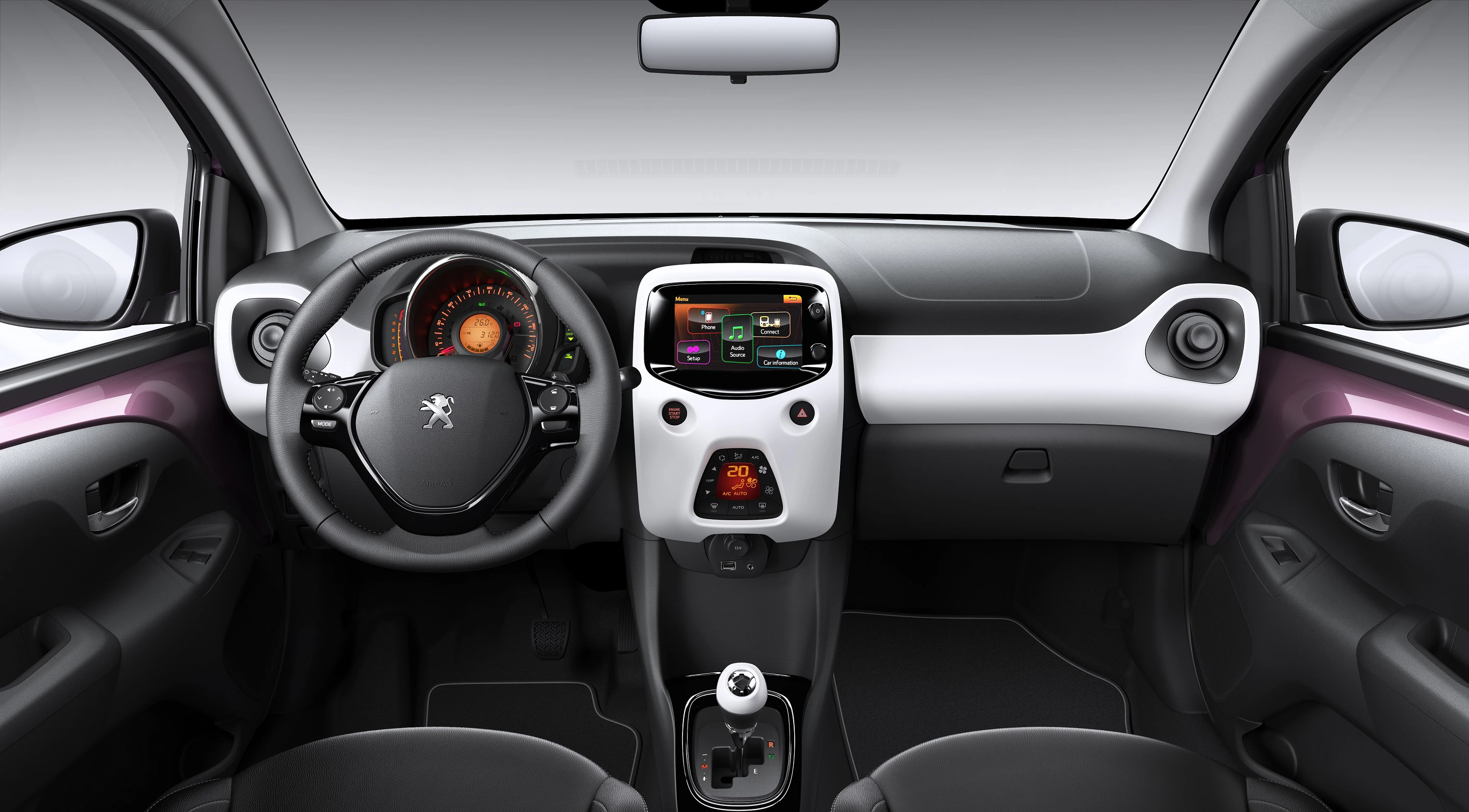 Innenraum eines modernen Autos mit Touchscreen-Display, schwarzem Lenkrad, Schalthebel und digitalem Tachometer.