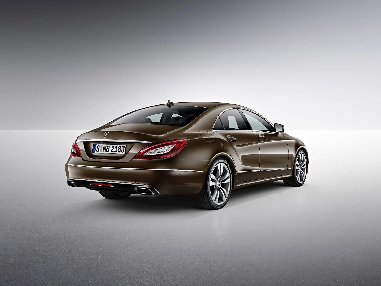 Brauner Mercedes-Benz CLS von hinten auf grauem Hintergrund, elegante Form und sportliches Design.