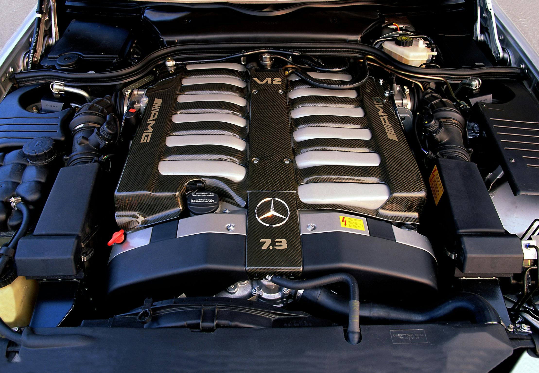 Nahaufnahme eines Mercedes-Benz V12 AMG-Motors. Sichtbar sind Abdeckungen mit AMG-Schriftzug und 7.3-Markierung.