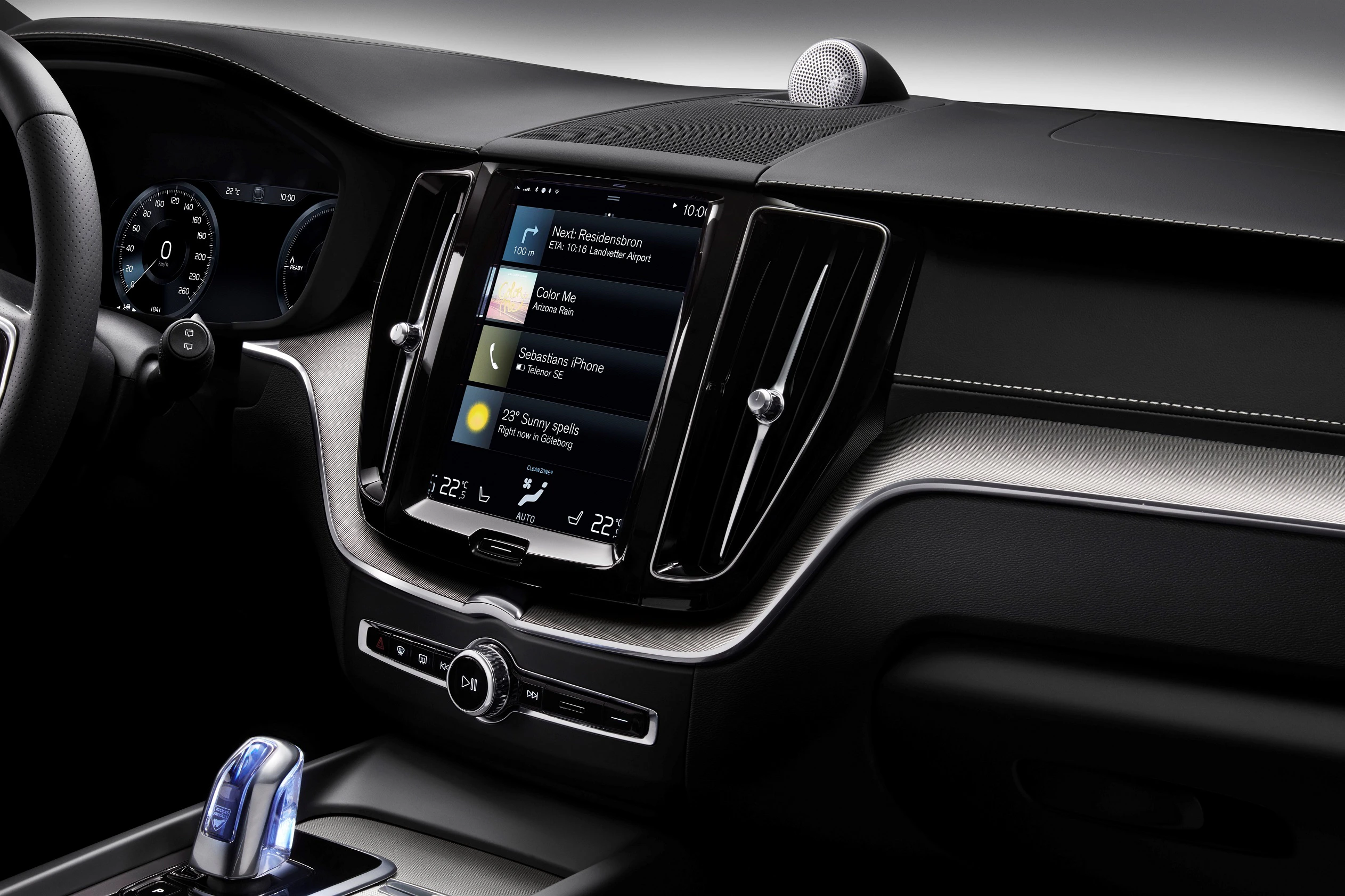Nahaufnahme eines modernen Auto-Armaturenbretts mit Touchscreen-Display, Geschwindigkeitsanzeige und eleganten, dunklen Verkleidungen.