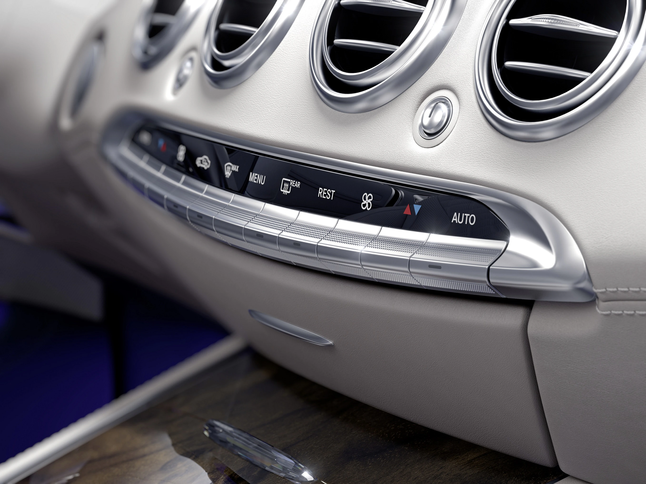 Nahaufnahme eines silbernen Armaturenbretts mit Lüftungsdüsen und Bedienelementen in einem Auto, moderner und eleganter Stil.