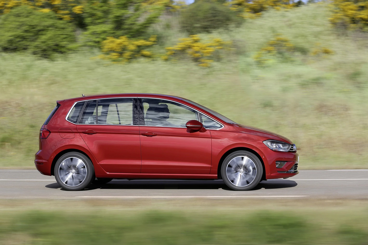 VW Golf Sportsvan Aussenansicht Seite dynamisch rot