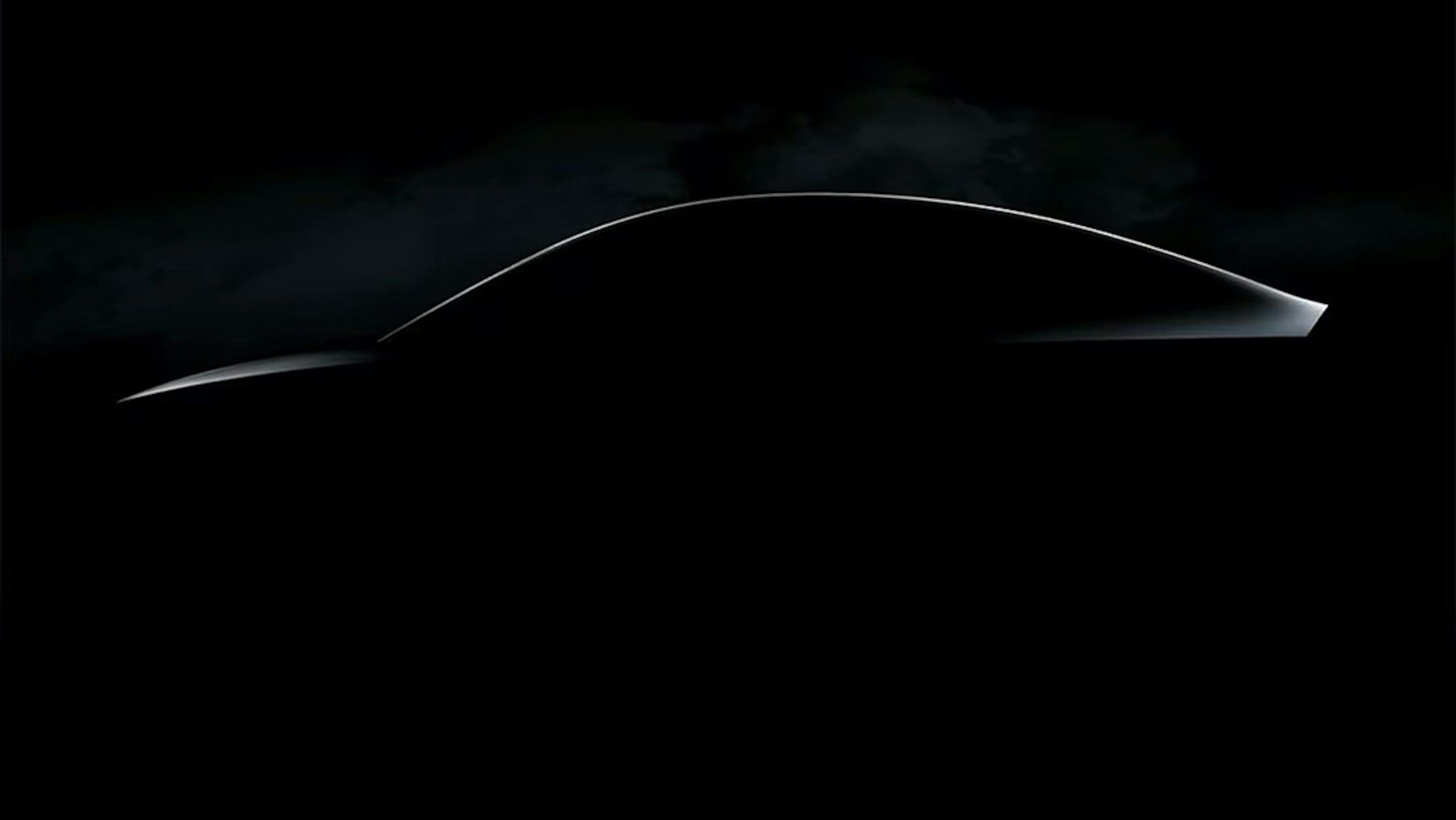 A black image with the implied silhouette of a Tesla.