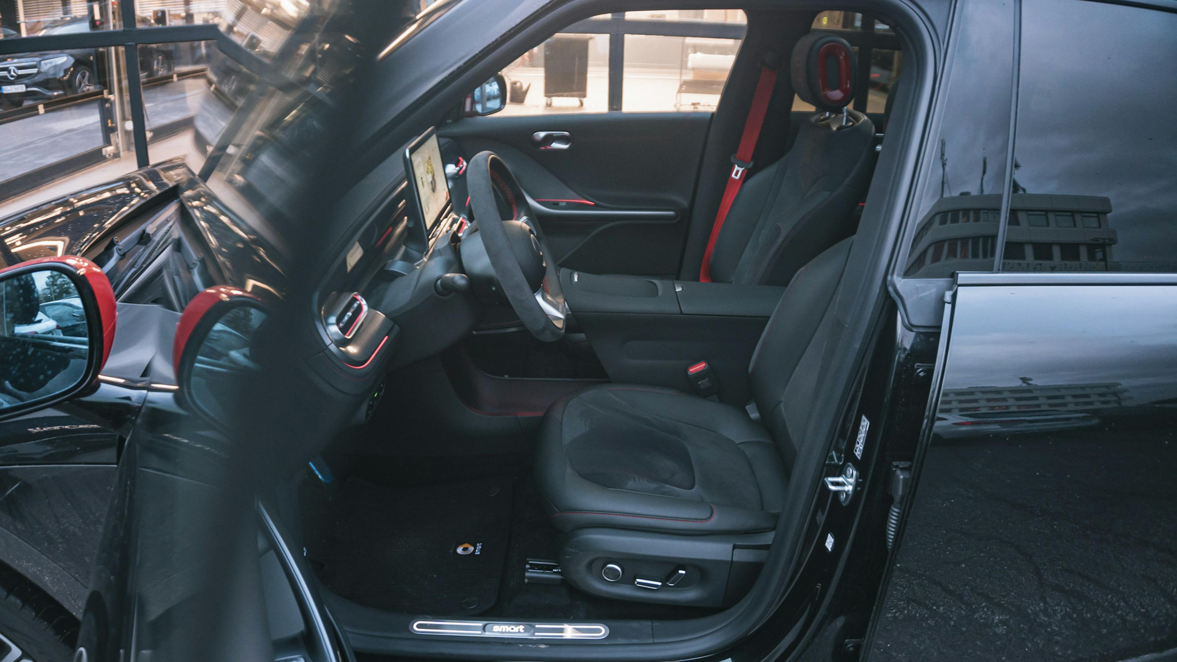 Ein Smart #1 Brabus mit offener Fahrertür.