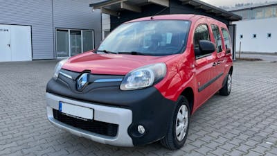 Ein roter Renault Kangoo Z.E. steht vor einem grauen Gebäude.
