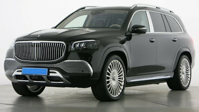 Ein schwarzer Mercedes Maybach GLS 600 steht in einem Raum mit weißen Wänden und grauem Boden.