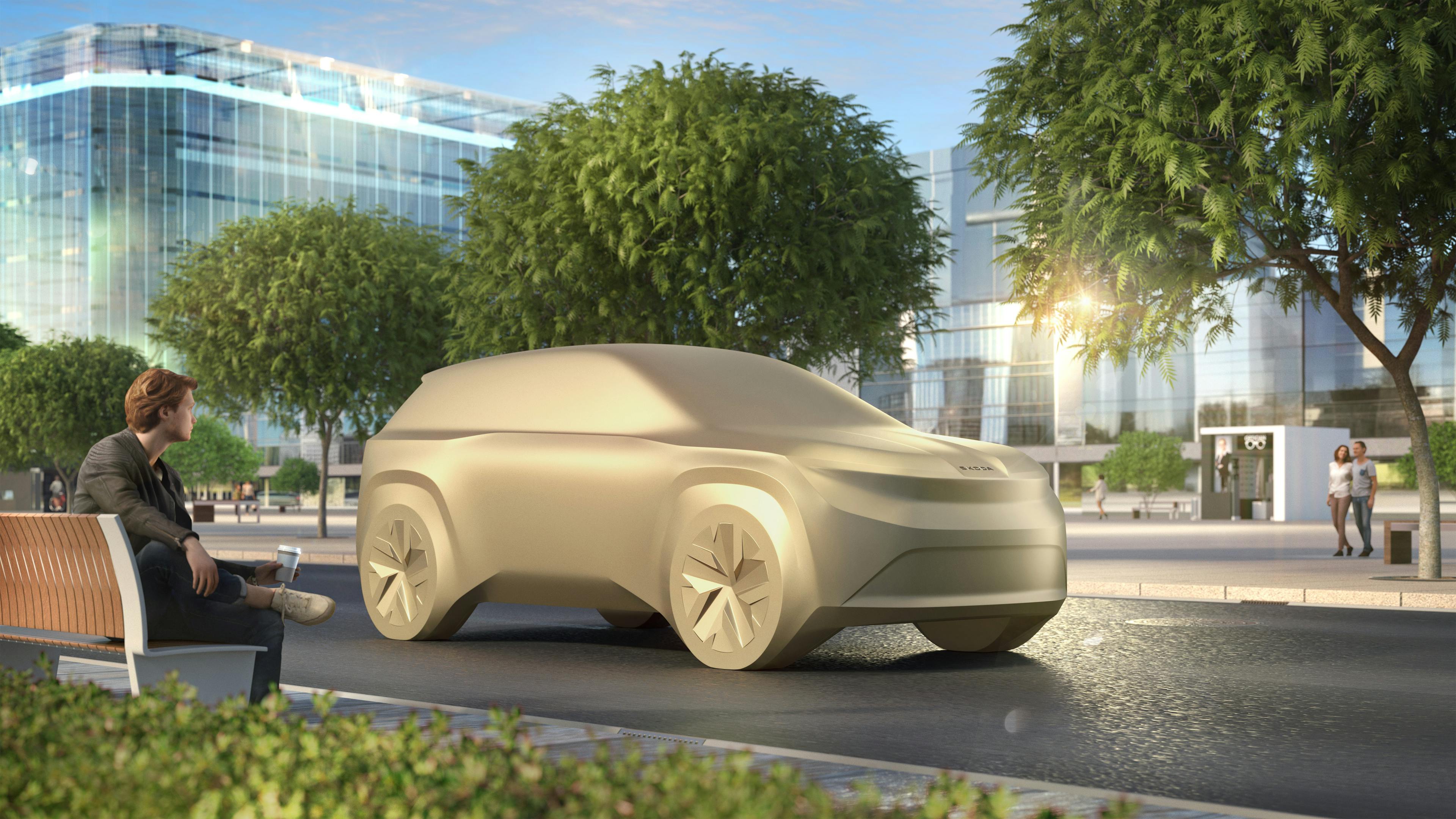 A model of an upcoming Škoda vehicle against an urban background.