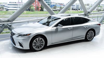 Ein silberner Lexus LS steht im Showroom eines Autohauses vor einer Fensterfront