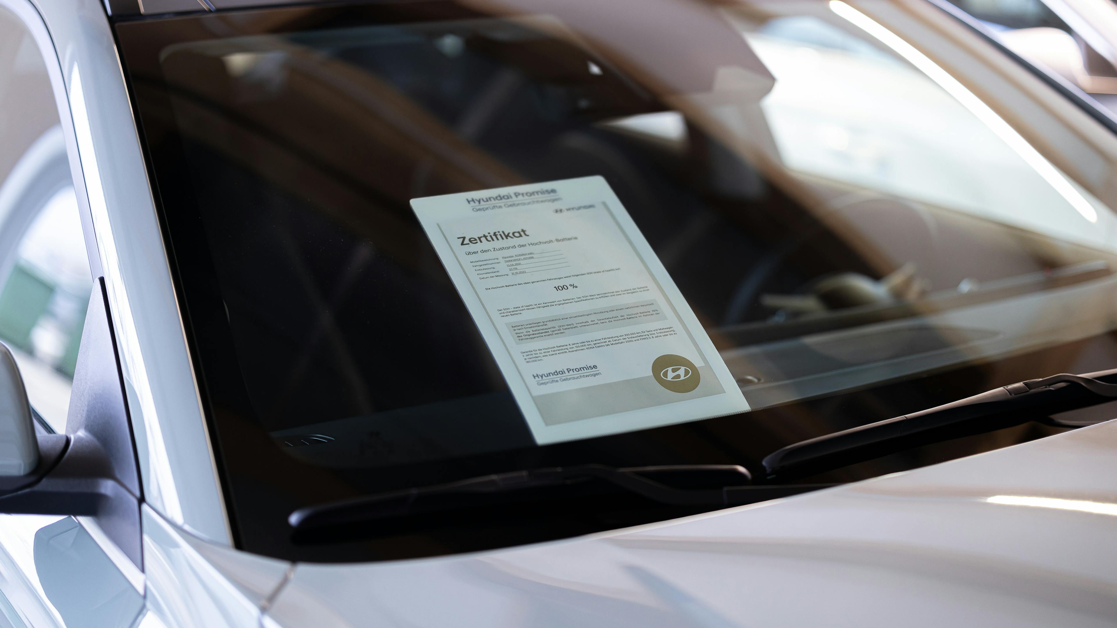 Battery Certificate behind the windshield of a car