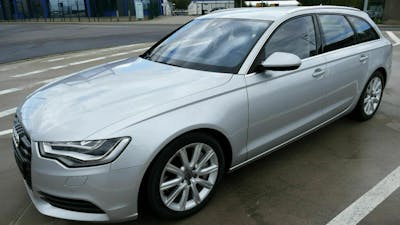 Ein silberner Audi A6 steht auf einem leeren Parkplatz