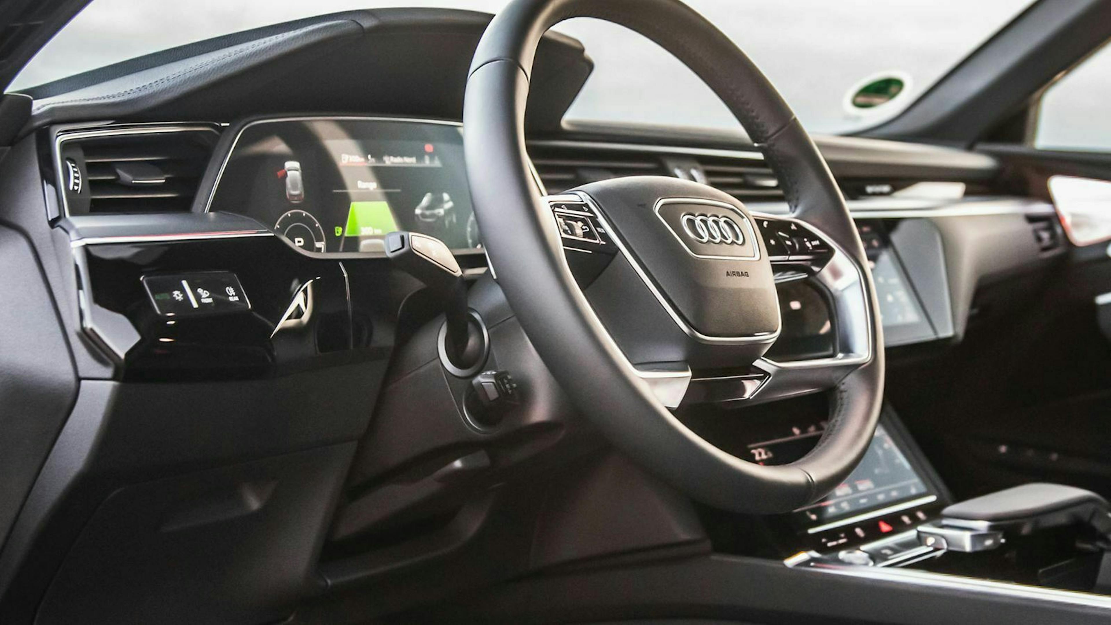 In einem Audi-Cockpit ist der Bedienhebel für den Tempomat unterhalb des Lenkstockhebels für den Blinker zu sehen. 