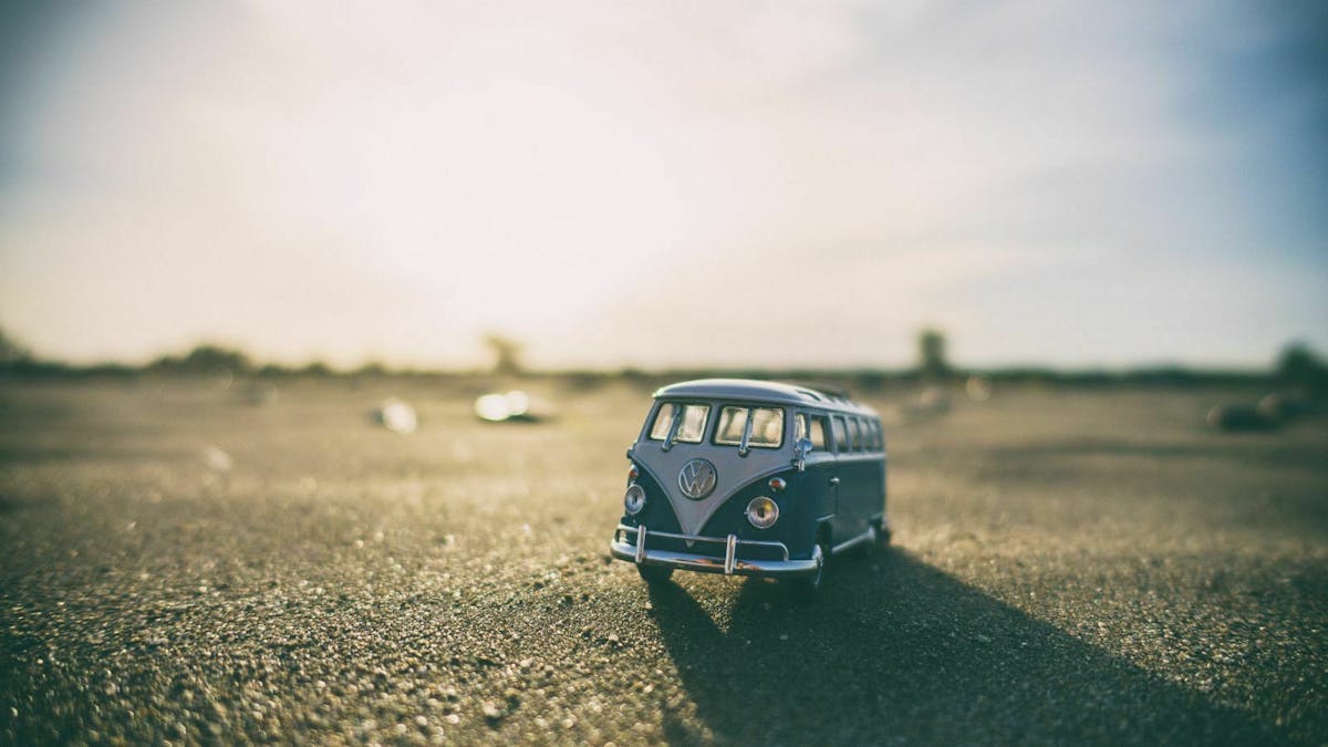 Eine Miniatur eines VW Busses steht auf einem Parkplatz