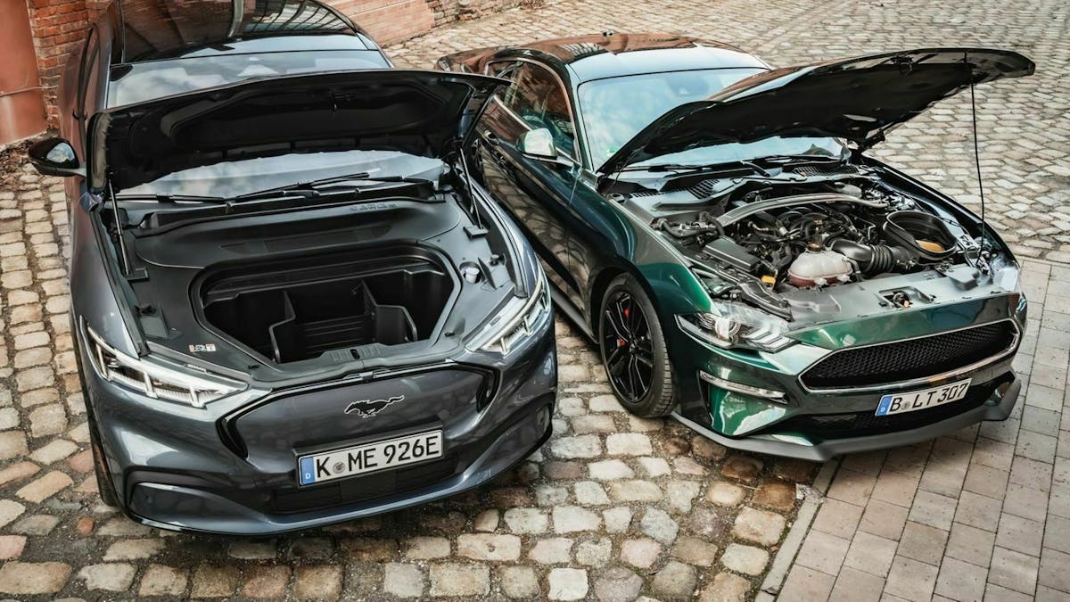 Zu sehen sind der Ford Mustang Mach-E (links) und der Ford Mustang Bullitt (rechts) mit geöffneter Haube