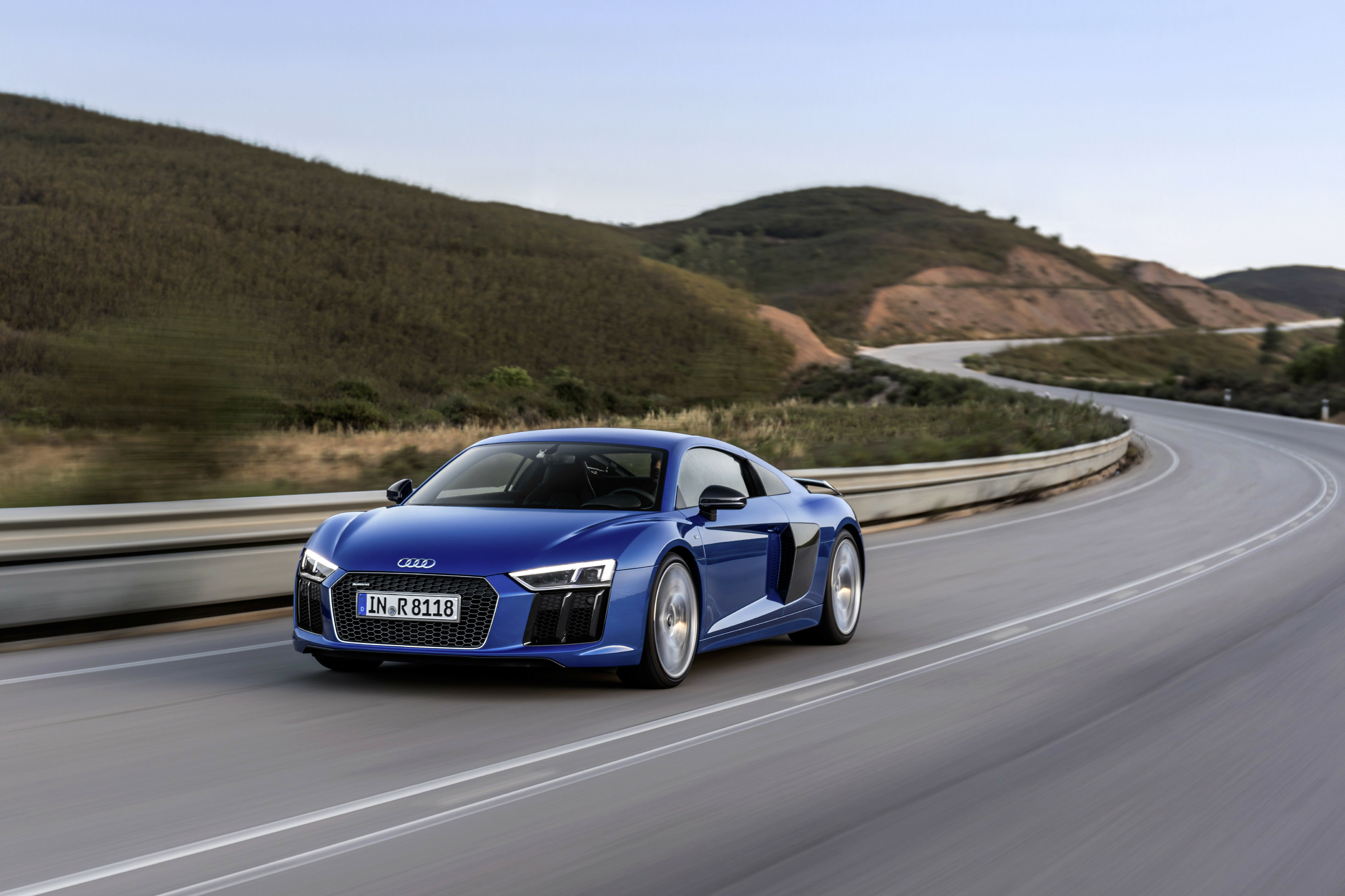 Ein blauer Audi R8 V10 fährt auf einer Landstraße.